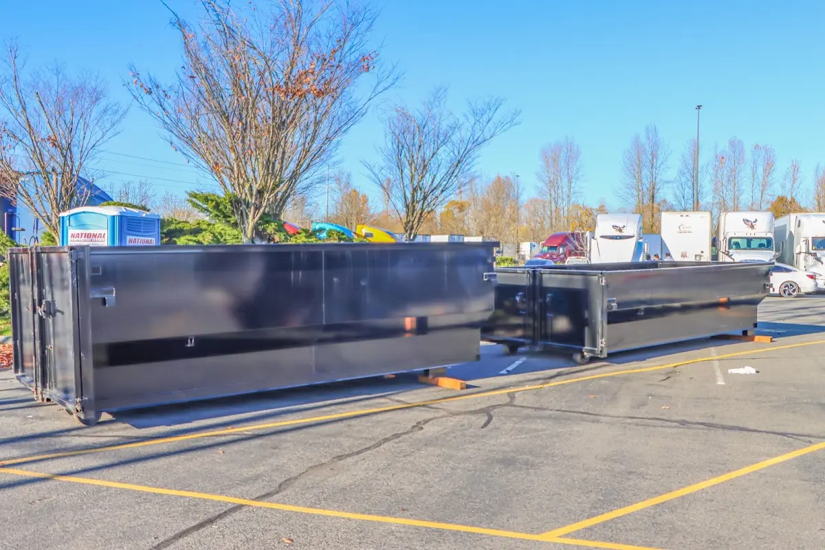 Professional dumpster rental service with roll-off container on residential driveway in Rumson